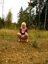 16 pictures - Blonde with tattooed legs pees near forest edge
