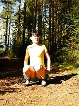 16 pictures - Cute brunette squats down to take a leak in forest
